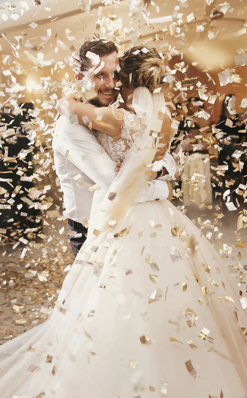Bride and Groom on their Wedding Day covered in Confetti
